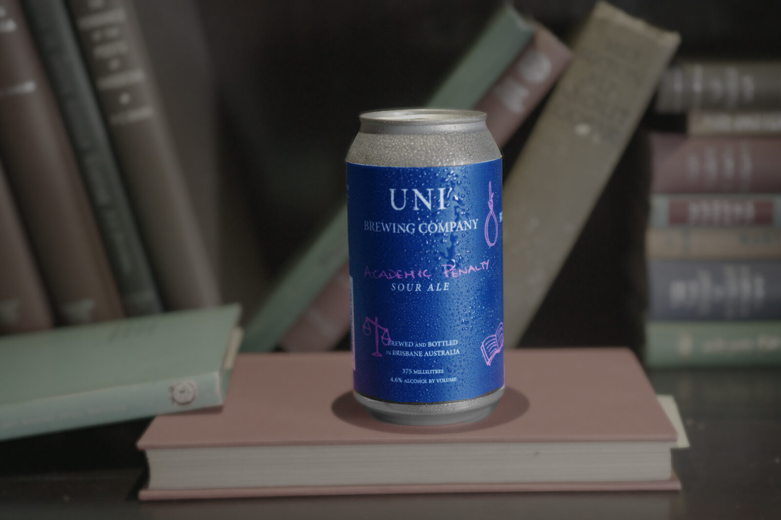 Uni Brewing Company Academic Penatly Sour Ale beer can on a bookshelf.