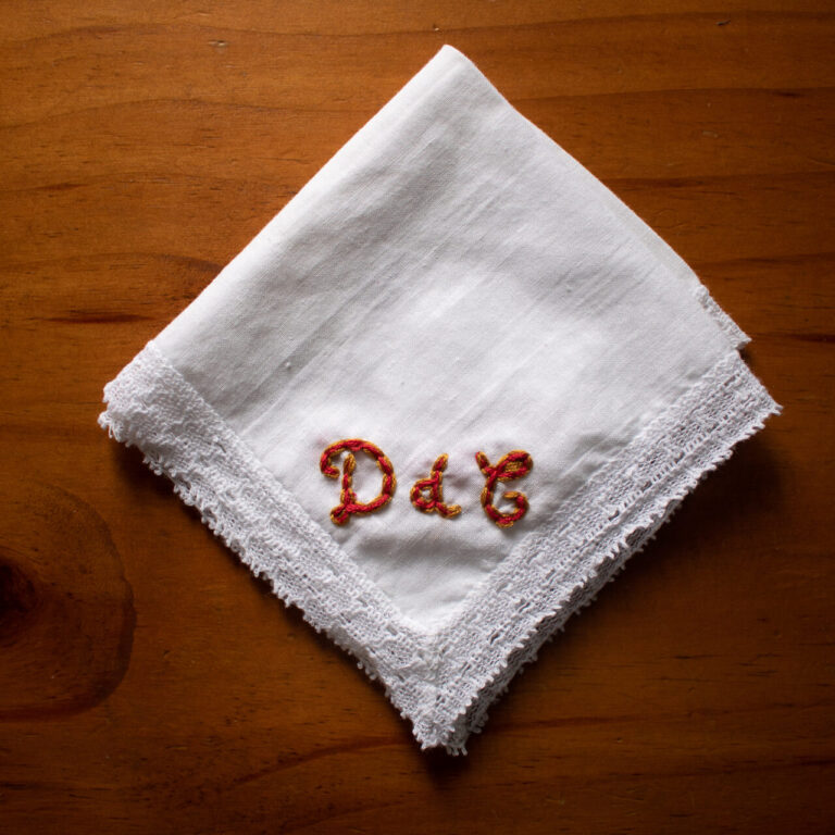 Embroidered initials, DdC, on handkerchief.